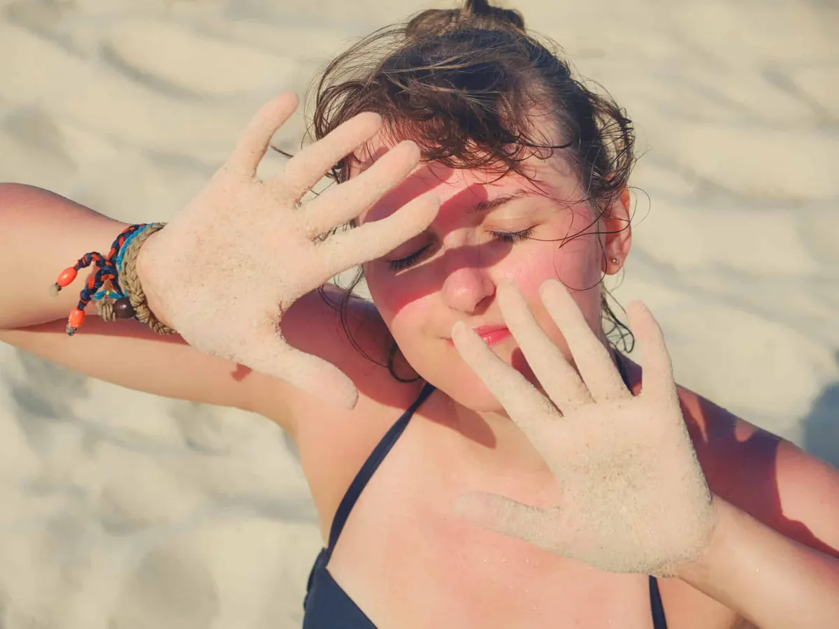 Woman getting too much sun exposure on a beach near Irvine