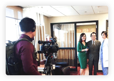 A television camera crew filming an interview inside the office lobby