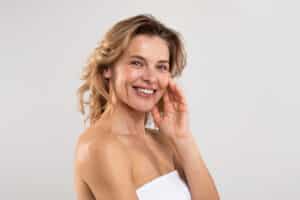 Self Care Concept. Closeup Portrait Of Joyful Middle Aged Female With Beautiful Skin