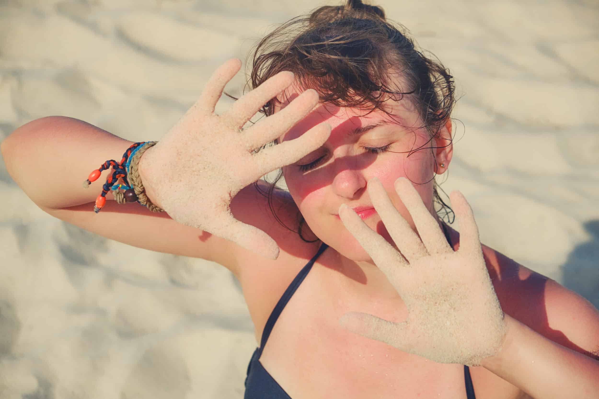 Woman getting too much sun exposure on a beach near Irvine