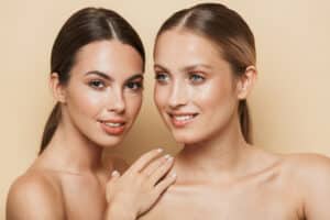 Two women with fresh, glowing, clear skin after receiving laser treatments in OC